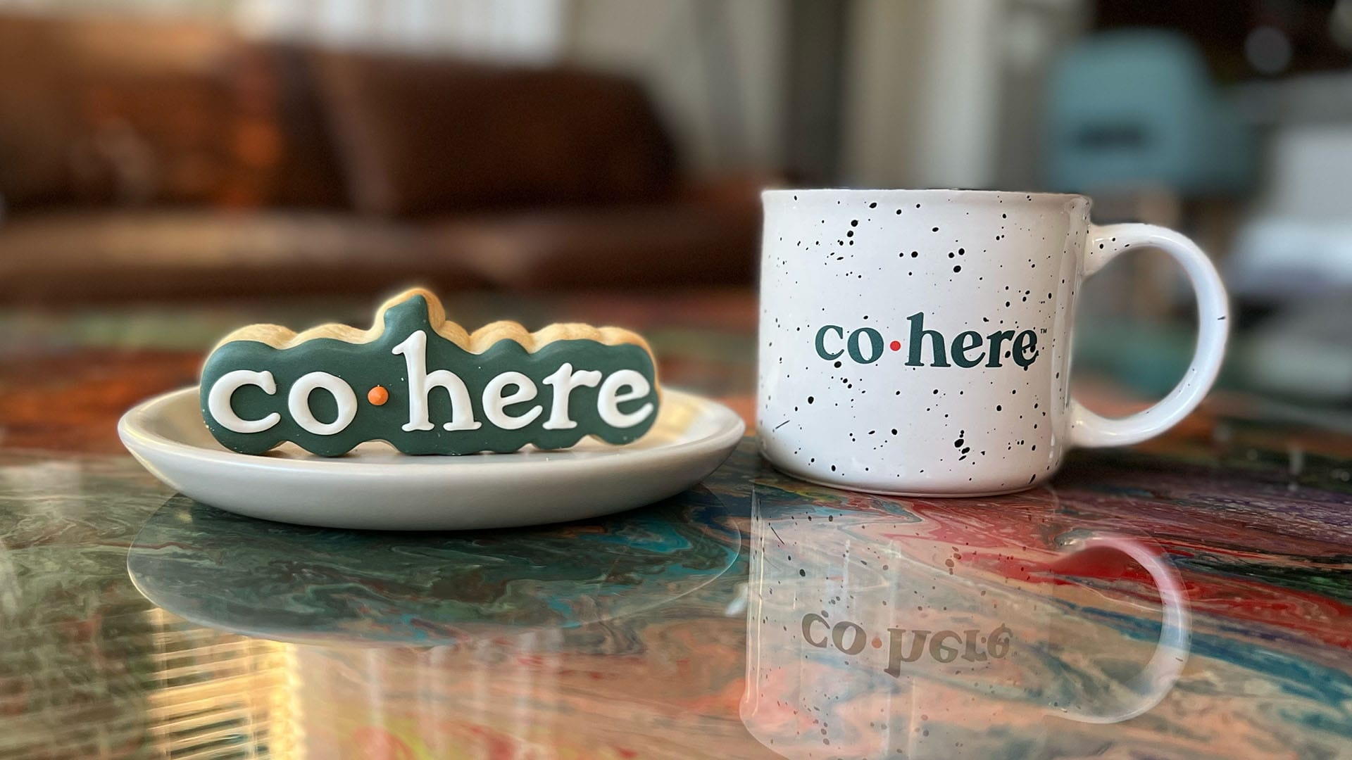 Cohere coffee mug and cookie sitting on a coffee table