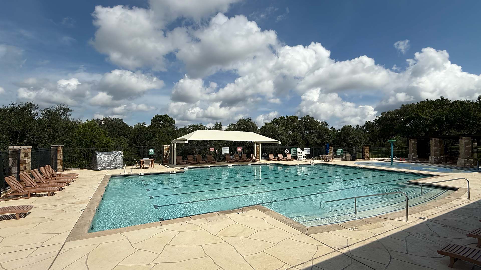 Pool on a beautiful day with blue skies and white puffy clouds