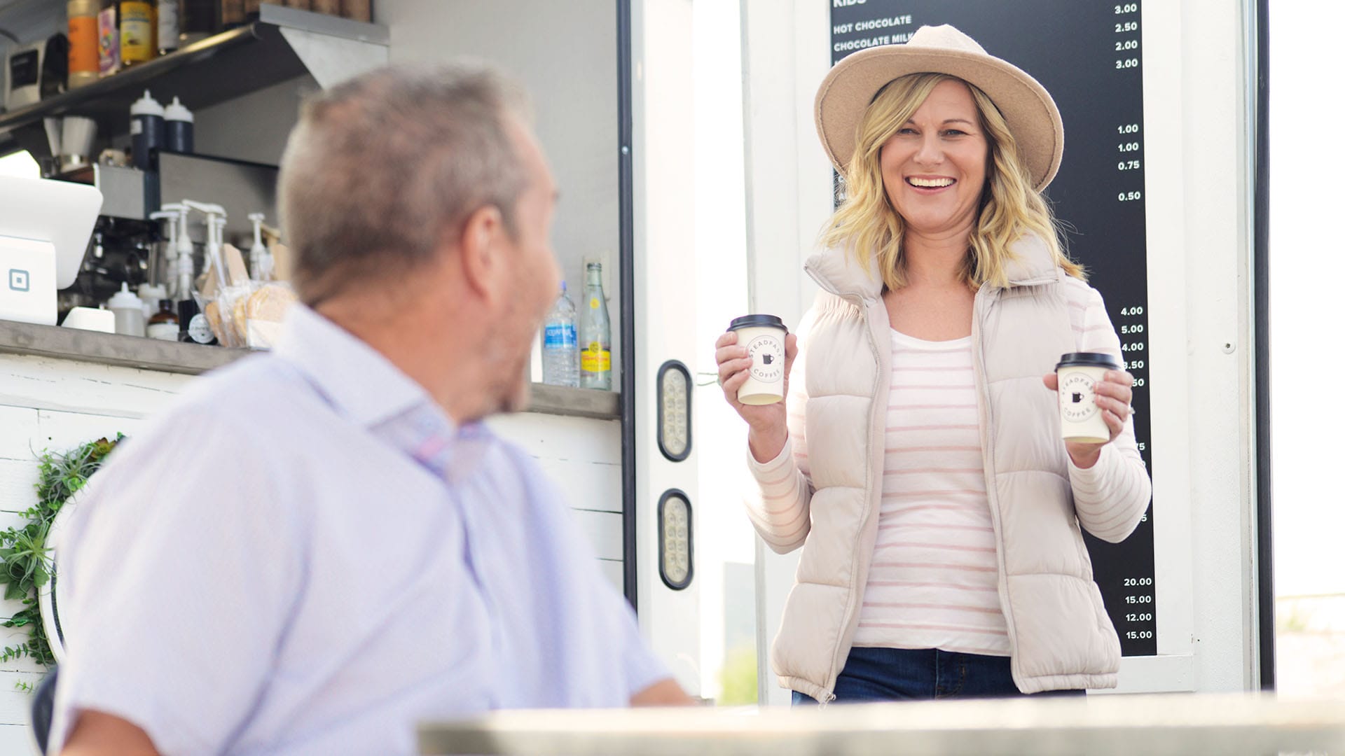 Resident bringing coffee to a neighbor at a coffee cart