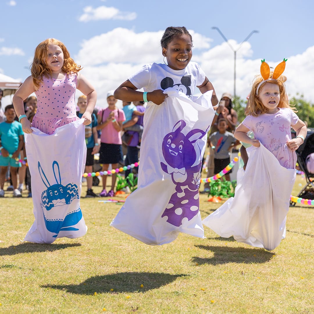 3 kids competing in sack race