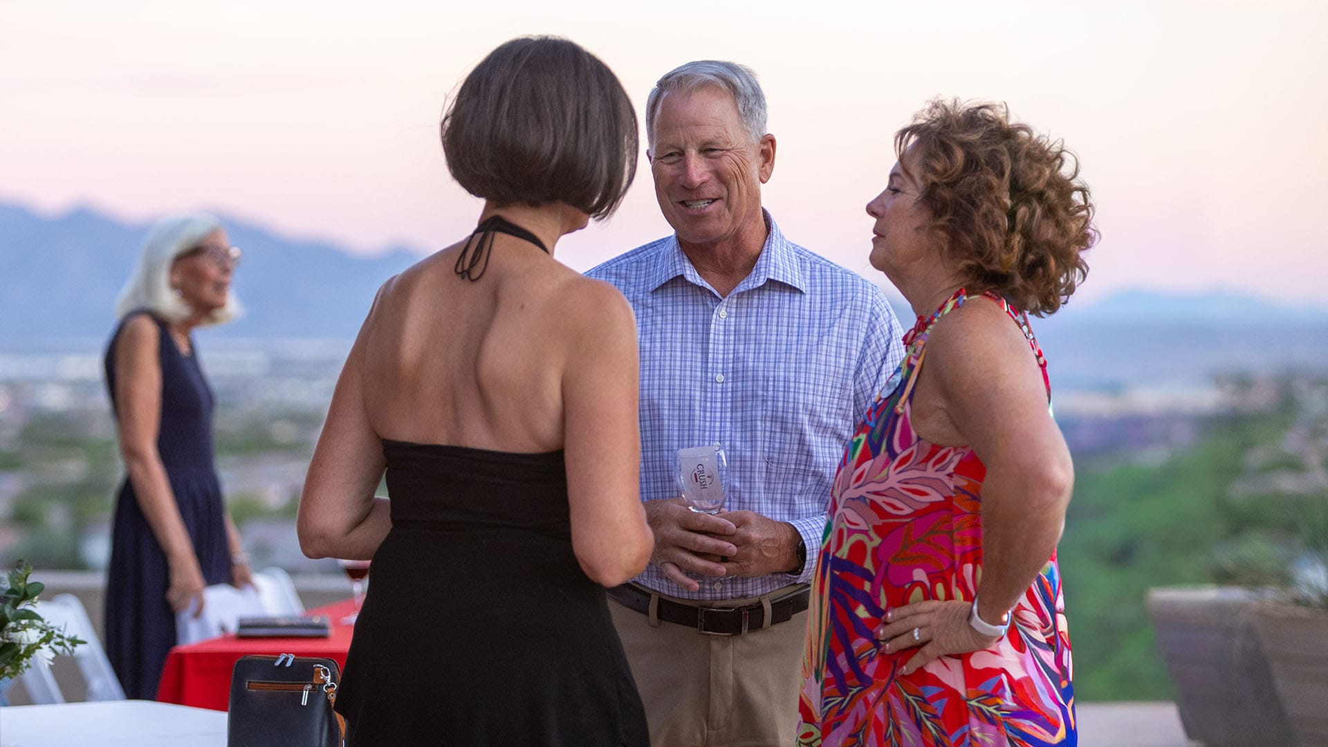 3 residents talking at an event