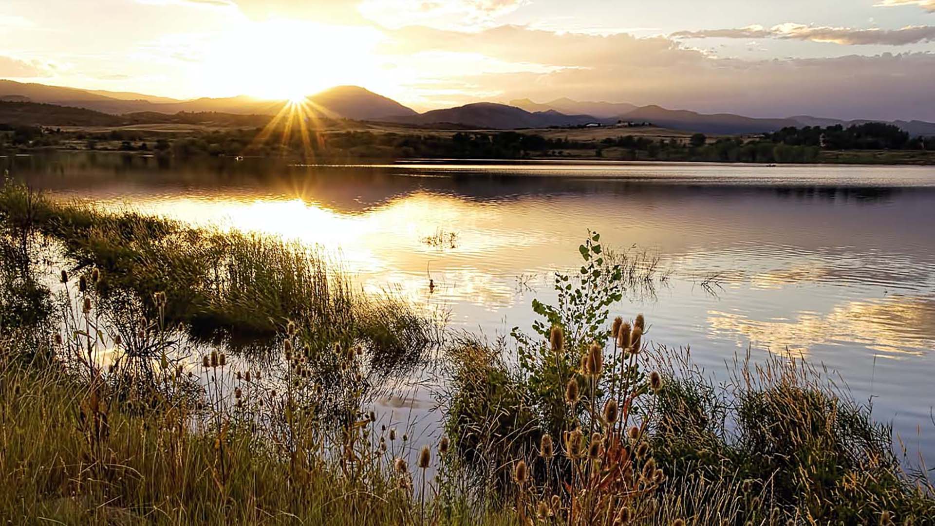 lake at sunset with mountains in background