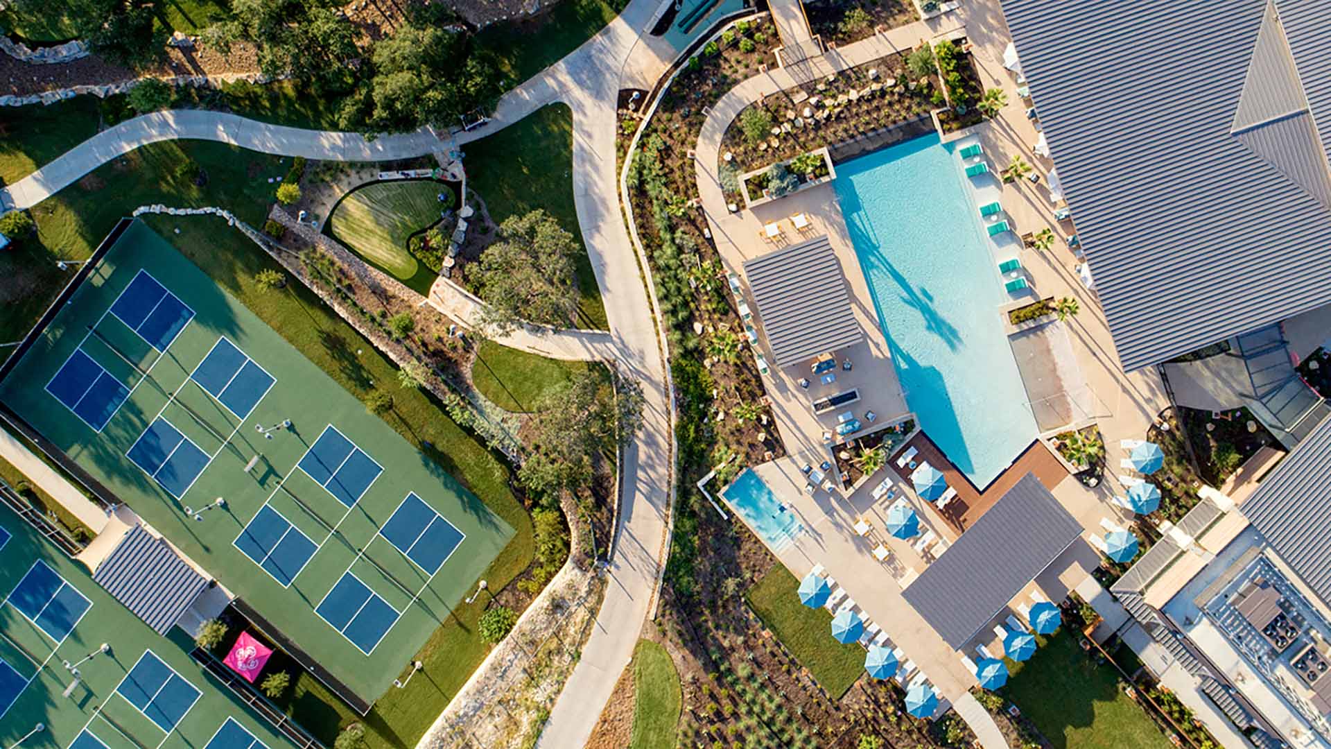 Drone shot of amenities, with pool and courts
