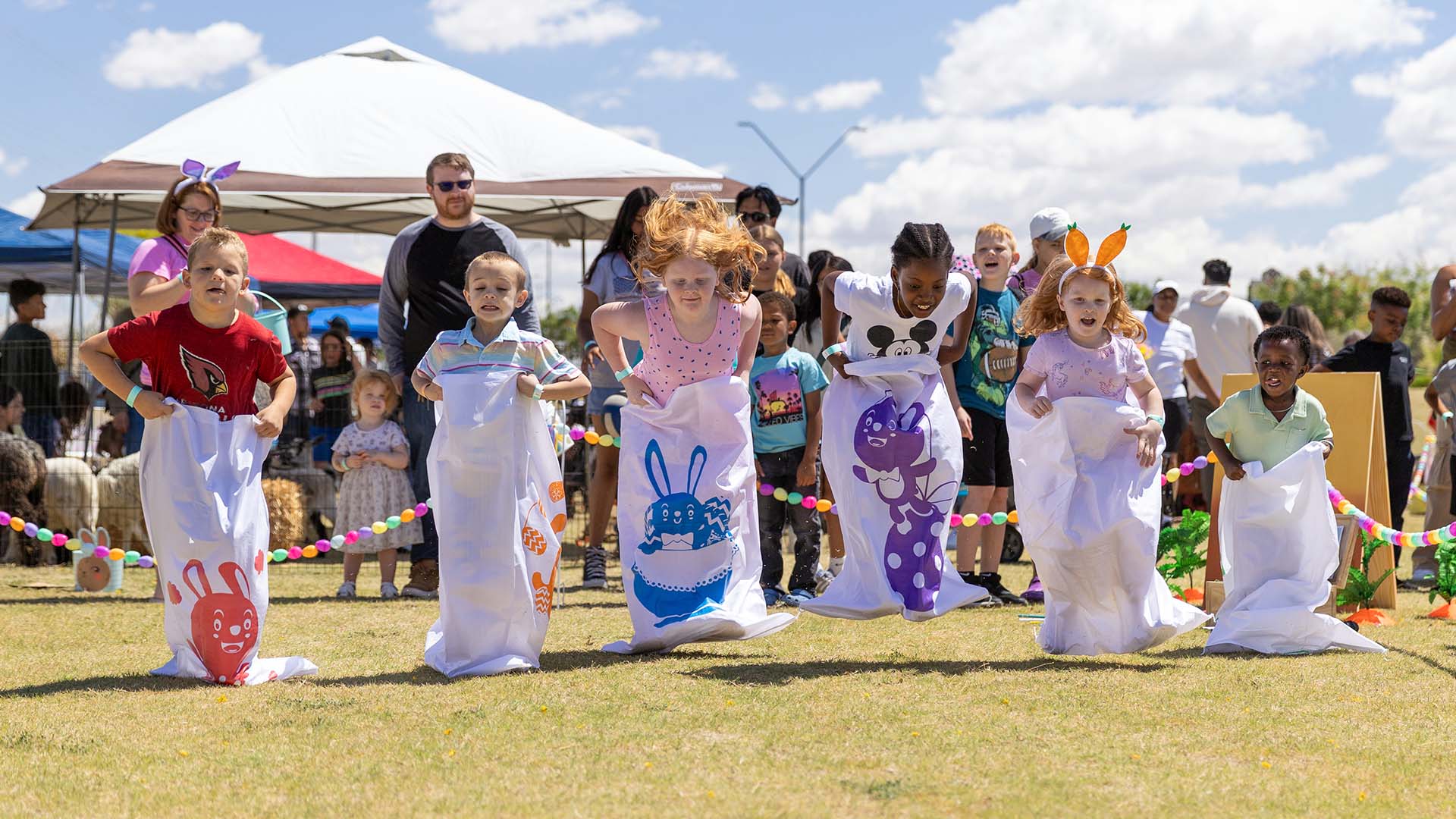 kids competing in a spring-themed sack race